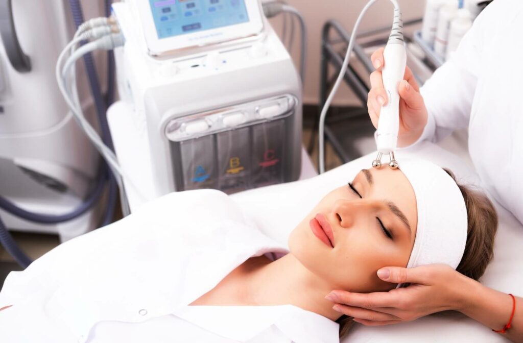 Woman receiving RF therapy for skin tightening procedure